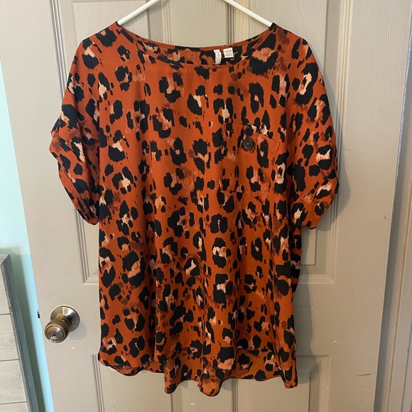 Cato Tops - Sexy leopard top with cuffed button sleeves. Throw on and go.
